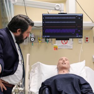 Board member Lawrence Shaheen Jr. views a nurse training manikin. 