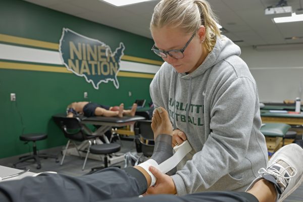 Female athletic training student wrapping an ankle in the classroom