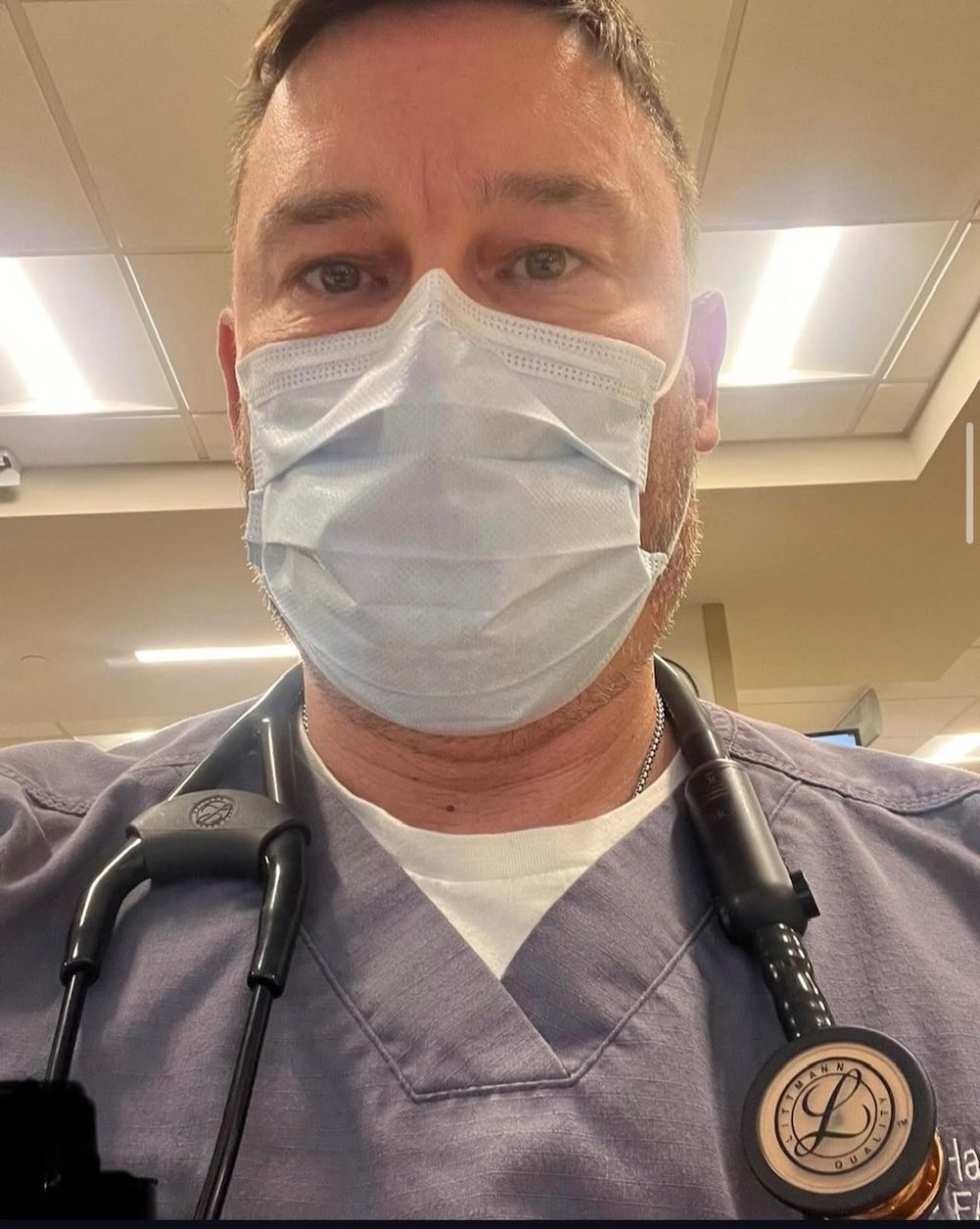 Male physician wearing a surgical mask and stethoscope