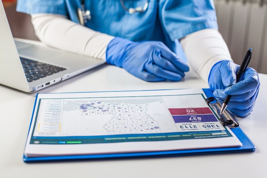 Nurse writing on clipboard