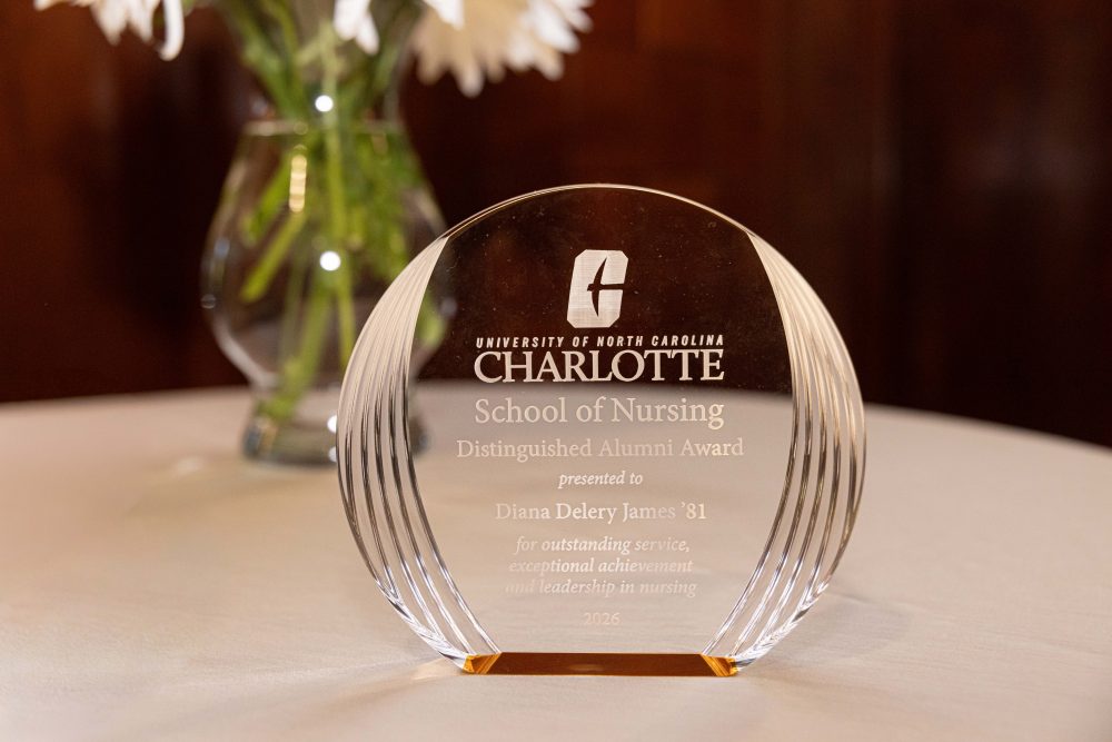 A clear glass award from the University of North Carolina Charlotte School of Nursing, presented to Diana Delery James '81 in 2026 for outstanding service, exceptional achievement, and leadership in nursing.